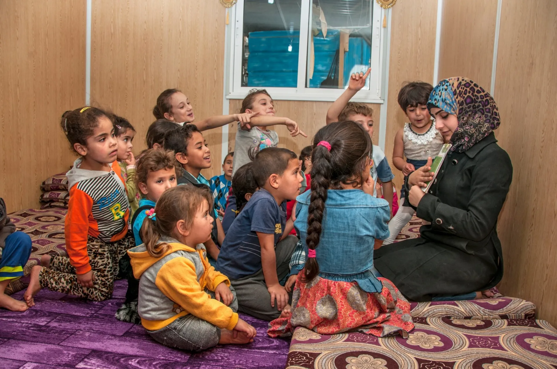 Asma, a Syrian refugee and We Love Reading ambassador, reading aloud.