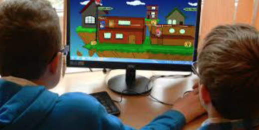 Two children completing working memory task on a computer